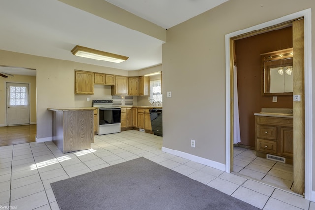 kitchen featuring plenty of natural light, light tile patterned flooring, white range, and dishwasher