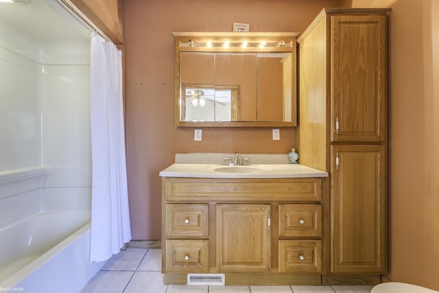 bathroom featuring shower / bathtub combination with curtain, tile patterned flooring, and vanity