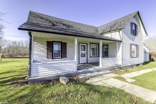 bungalow-style home featuring covered porch and a front lawn