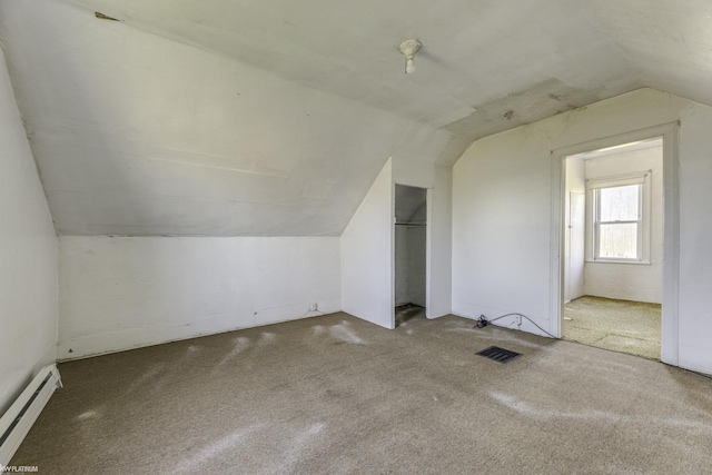 bonus room with baseboard heating, carpet, and lofted ceiling