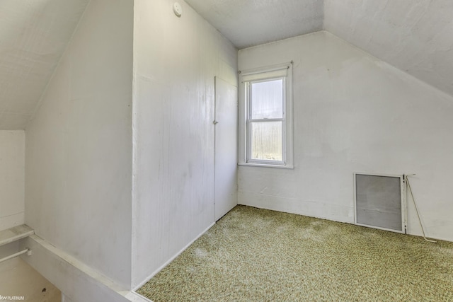 bonus room featuring carpet floors and vaulted ceiling