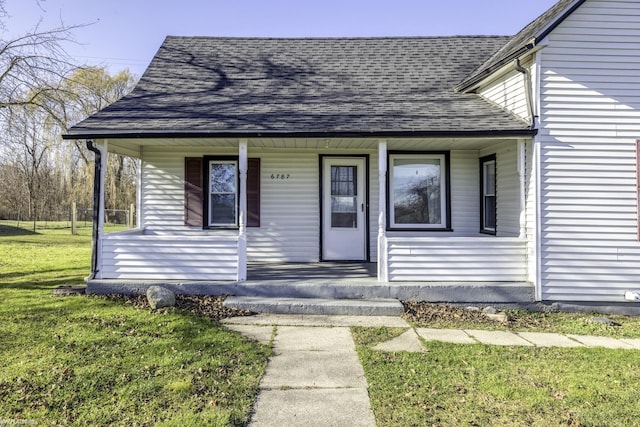 view of front of home featuring covered porch and a front yard