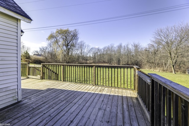 wooden terrace featuring a yard