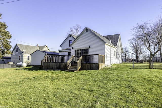 rear view of house with a wooden deck and a yard