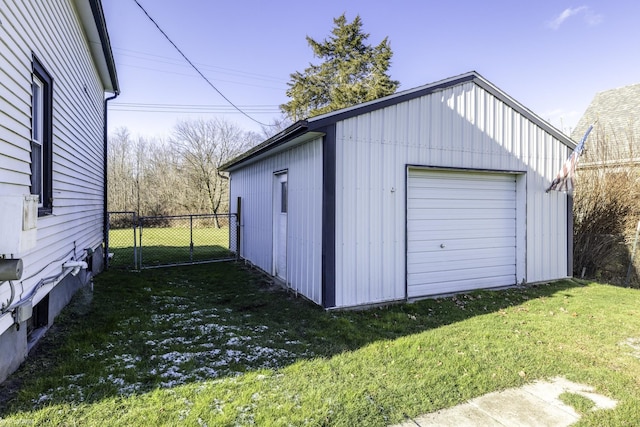 garage featuring a lawn