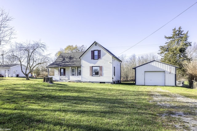 view of front of home featuring a garage, an outdoor structure, and a front lawn