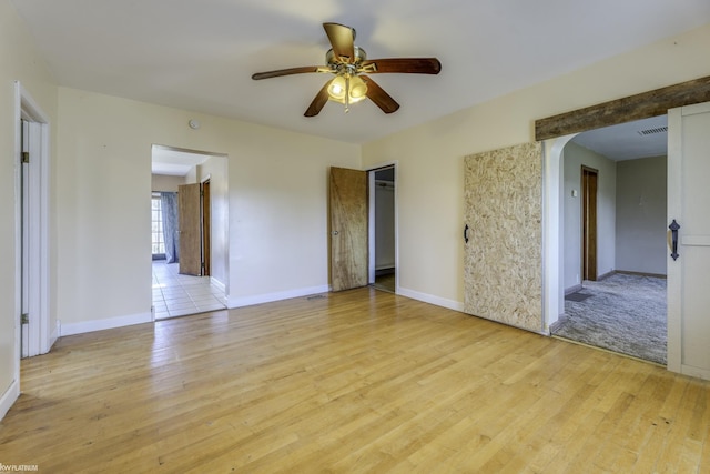 empty room featuring ceiling fan and light hardwood / wood-style flooring