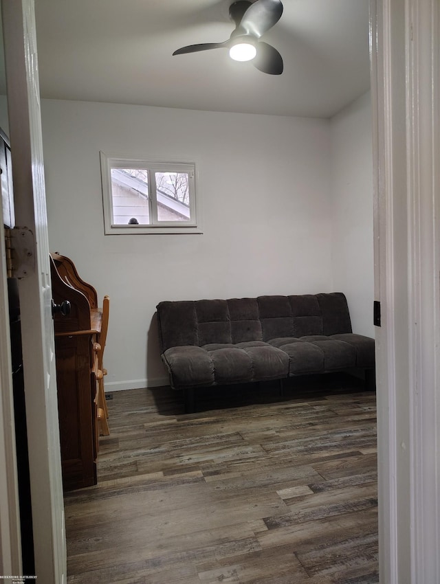 living room featuring ceiling fan and dark hardwood / wood-style flooring