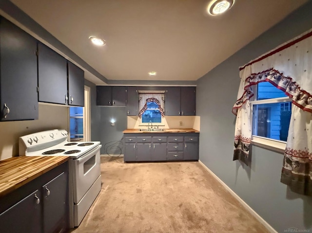 kitchen with white range with electric cooktop, wood counters, light colored carpet, and sink