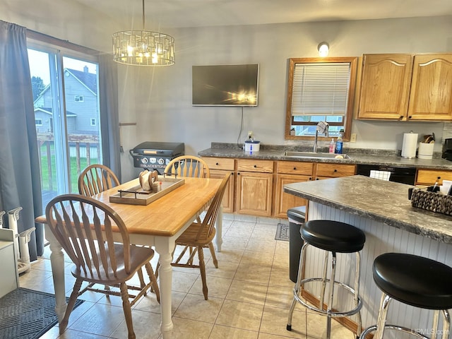 kitchen with dishwasher, sink, a chandelier, pendant lighting, and light tile patterned floors