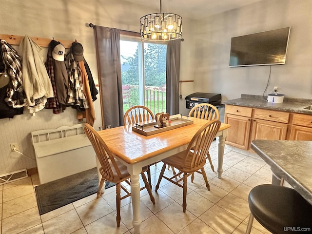 tiled dining space featuring an inviting chandelier