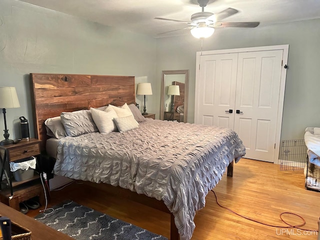 bedroom with hardwood / wood-style floors, a closet, and ceiling fan