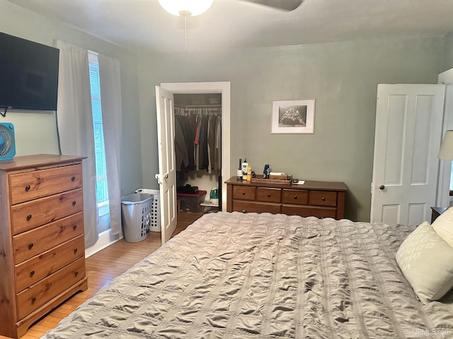 bedroom featuring ceiling fan, light wood-type flooring, and a closet