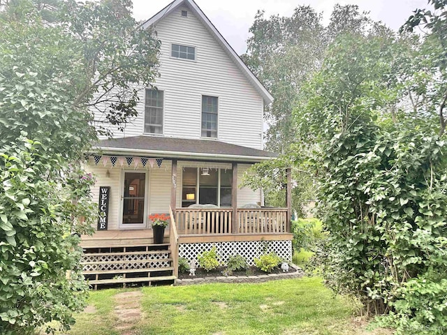 view of front of property with covered porch and a front lawn