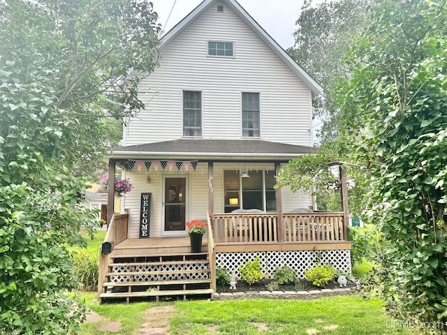 rear view of house featuring a porch