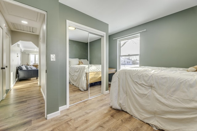 bedroom with a closet and light hardwood / wood-style flooring