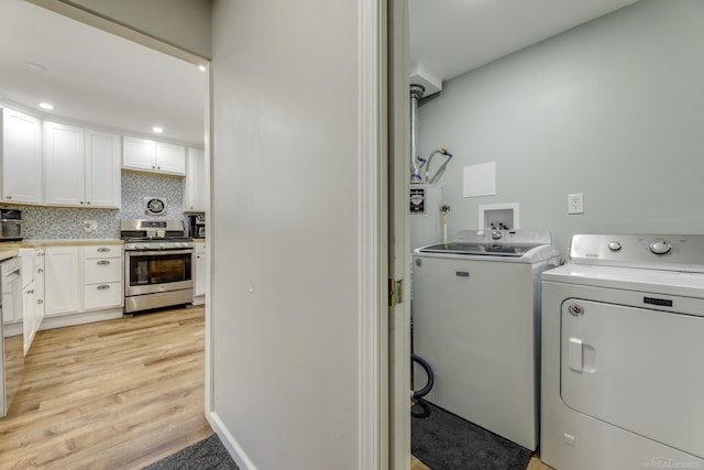 laundry area featuring light hardwood / wood-style floors and independent washer and dryer