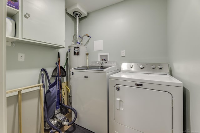 washroom featuring washer and dryer and cabinets