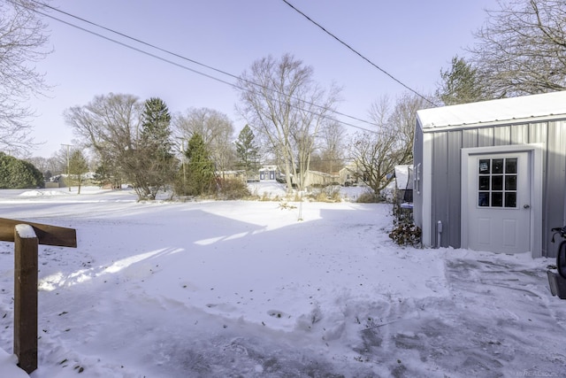 snowy yard with a storage unit