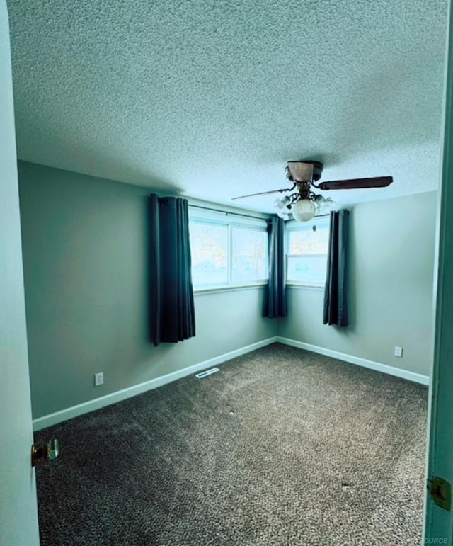 empty room featuring carpet, a textured ceiling, and ceiling fan