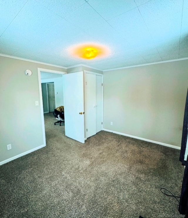 spare room featuring crown molding and carpet flooring