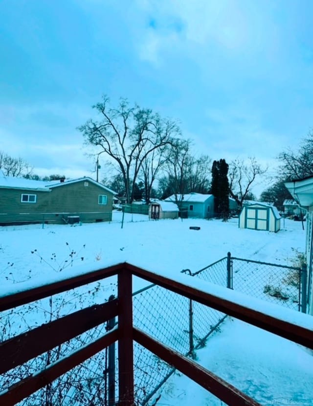 snowy yard with a shed