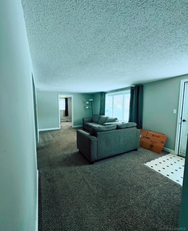 living room featuring a textured ceiling and dark carpet