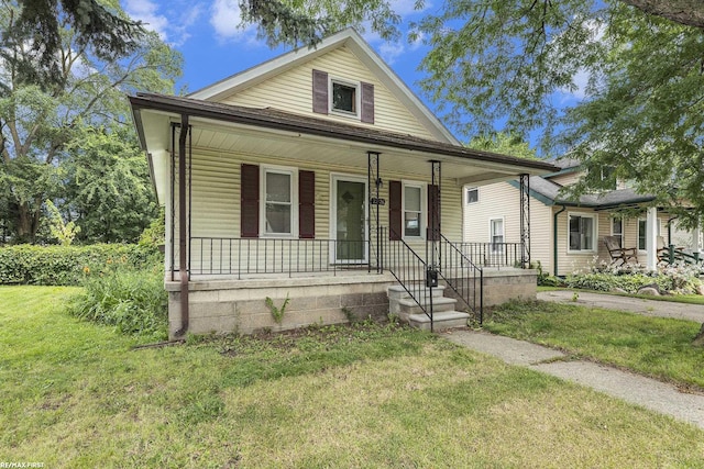 view of front of property with covered porch and a front lawn