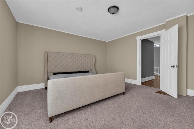 bedroom with carpet flooring, a textured ceiling, and ornamental molding