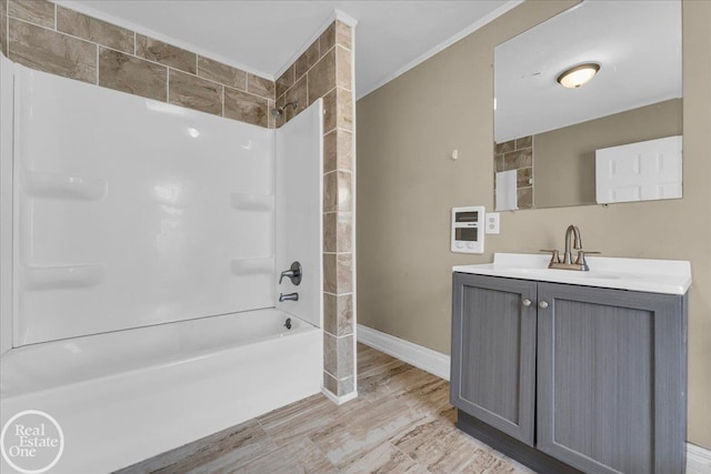 bathroom with wood-type flooring, vanity, shower / washtub combination, and ornamental molding