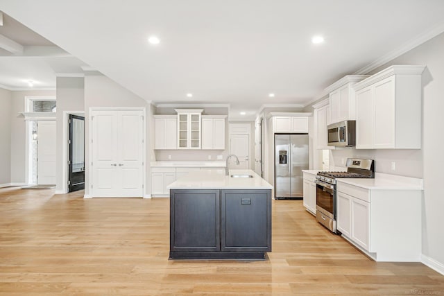 kitchen with white cabinets, sink, light wood-type flooring, and stainless steel appliances