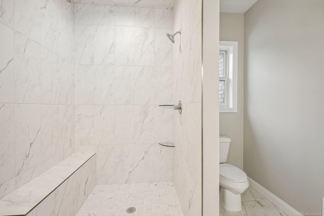 bathroom with toilet and tiled shower