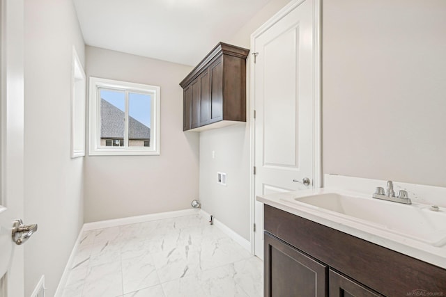 washroom with cabinets, washer hookup, gas dryer hookup, and sink