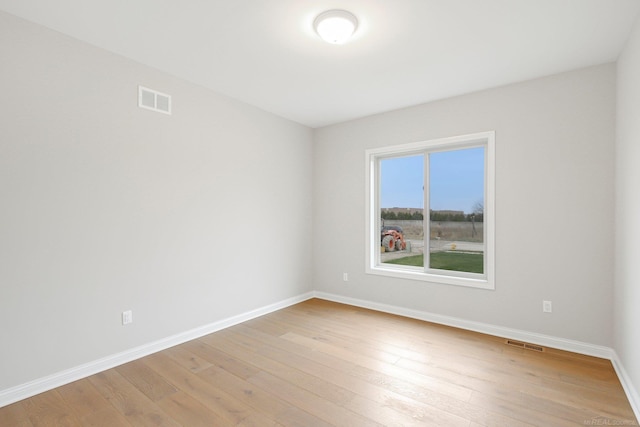 spare room featuring light hardwood / wood-style floors