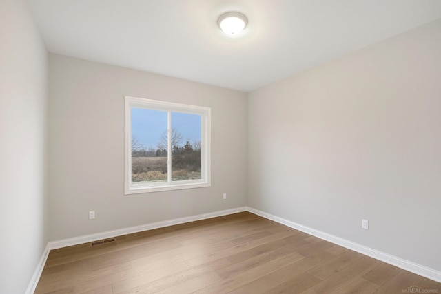 spare room featuring light wood-type flooring