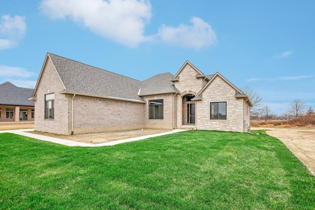 french provincial home featuring a front yard