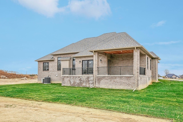 back of house featuring a lawn and cooling unit