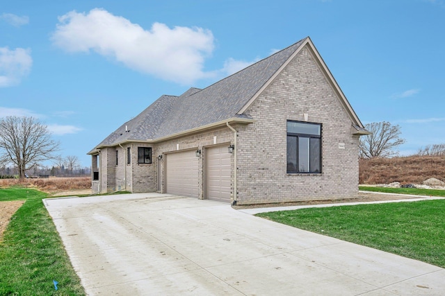 view of side of home featuring a garage and a lawn