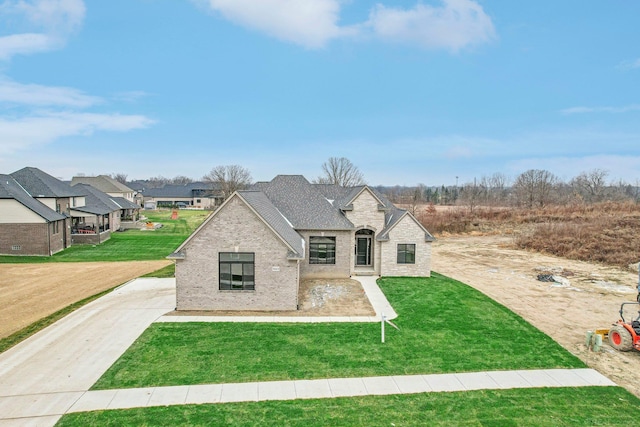 french country home featuring a front yard