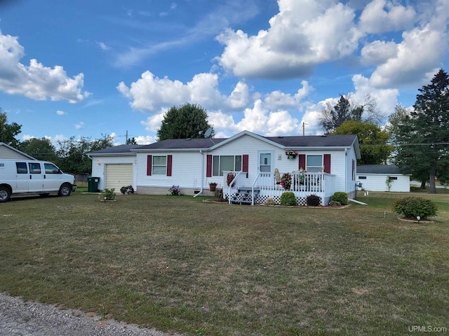 manufactured / mobile home with a garage and a front lawn