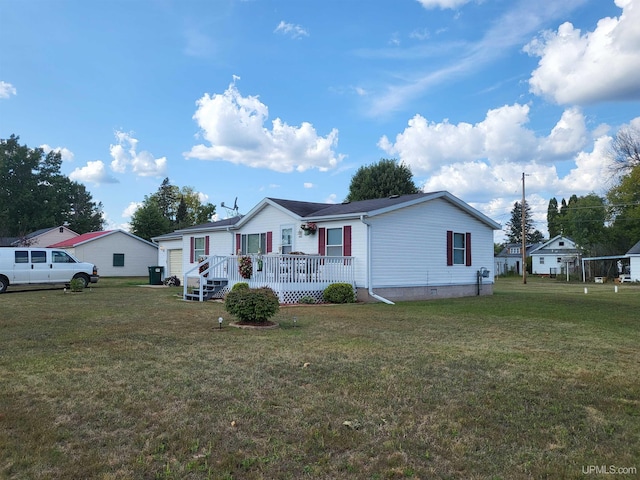 view of front of home with a deck and a front yard