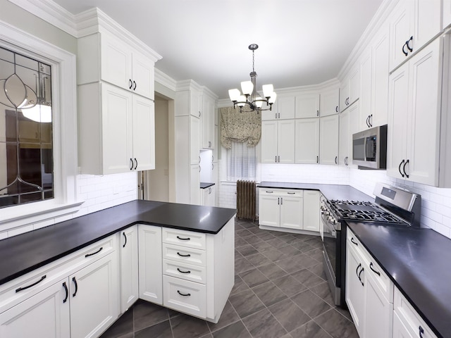 kitchen with appliances with stainless steel finishes, backsplash, and white cabinetry