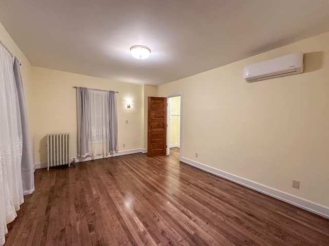 unfurnished bedroom featuring a wall unit AC, radiator heating unit, and dark wood-type flooring