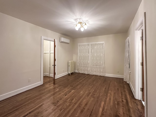 unfurnished bedroom with an AC wall unit, radiator, a closet, and dark wood-type flooring