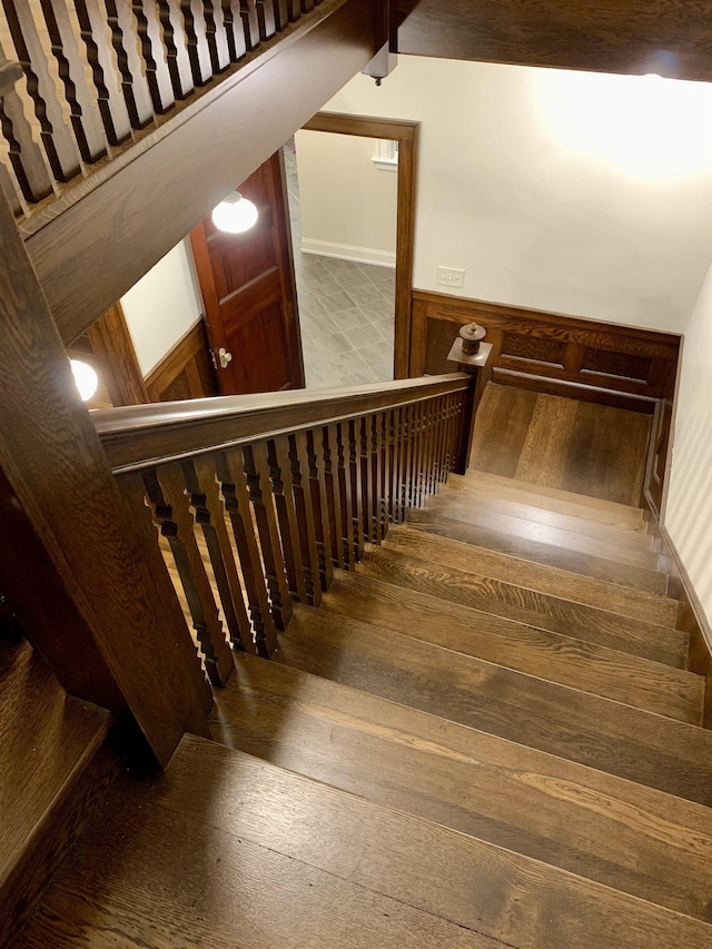 stairs with hardwood / wood-style floors and lofted ceiling with beams