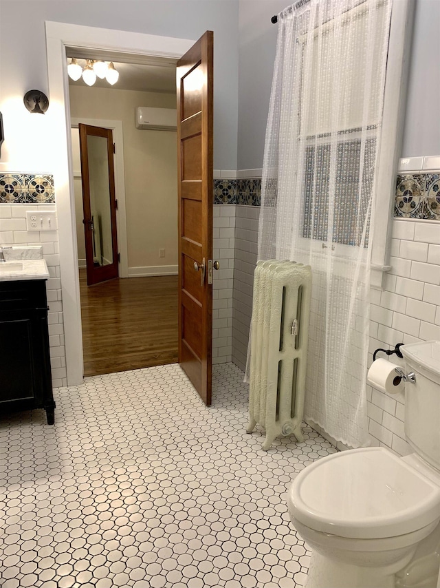 bathroom with toilet, an AC wall unit, radiator, and tile walls