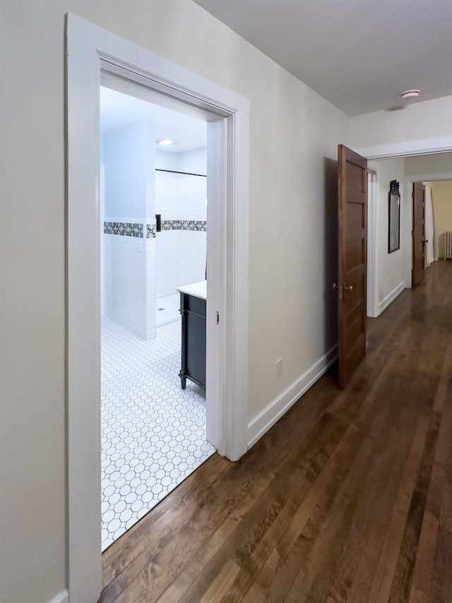 corridor with dark wood-type flooring