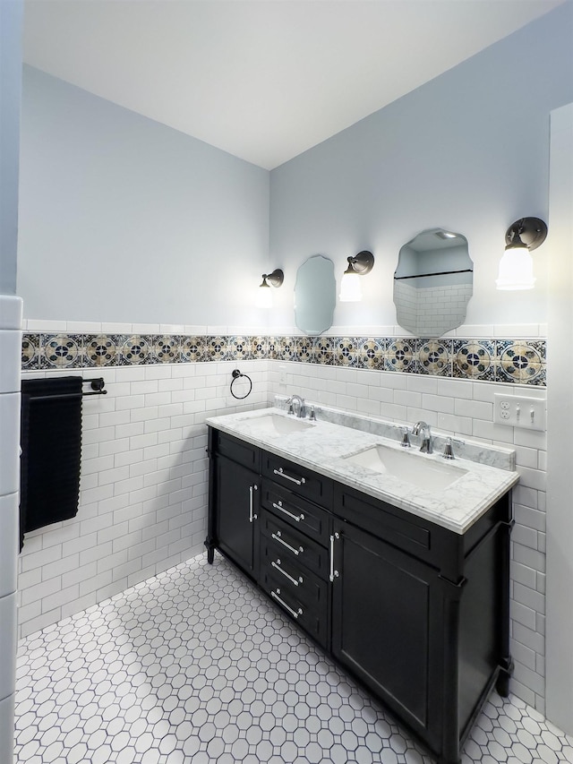 bathroom with tile patterned flooring, vanity, and tile walls