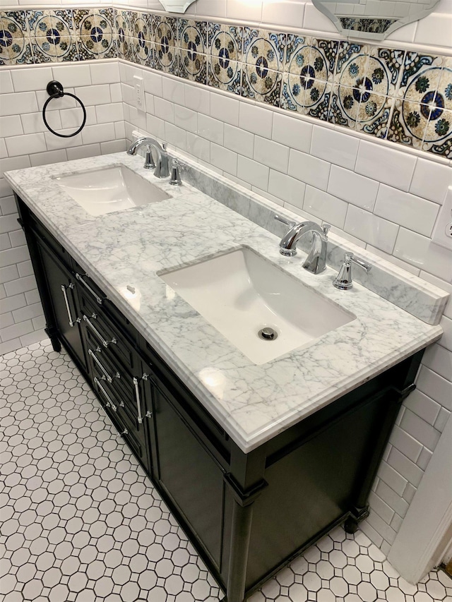 bathroom featuring tile patterned flooring, vanity, backsplash, and tile walls