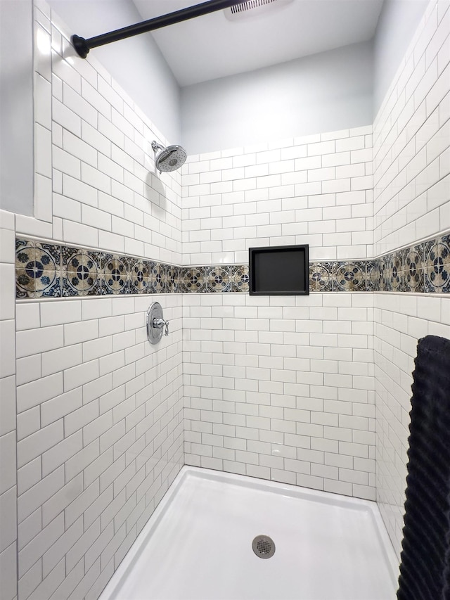 bathroom with tiled shower